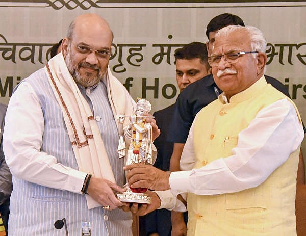Union Home Minister Amit Shah receives an idol of Lord Krishna from Haryana Chief Minister Manohar Lal Khattar during the 29th meeting of the Northern Zonal Council, in Chandigarh. (Photo/PTI)