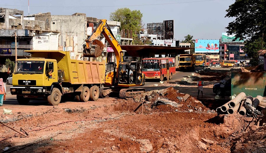 Earth movers digging the road near the Laxmi Circle in Dharwad on Sunday for laying drainage pipes.