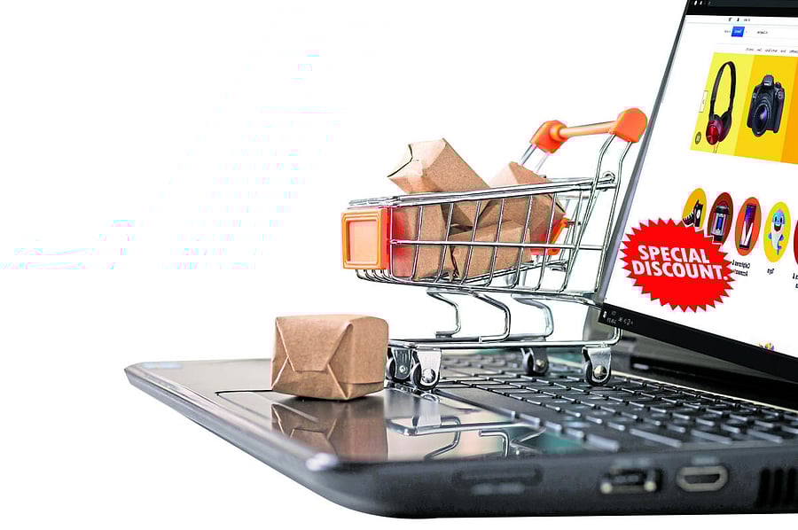 Online shopping concept. Shopping cart, small boxes, laptop on the desk