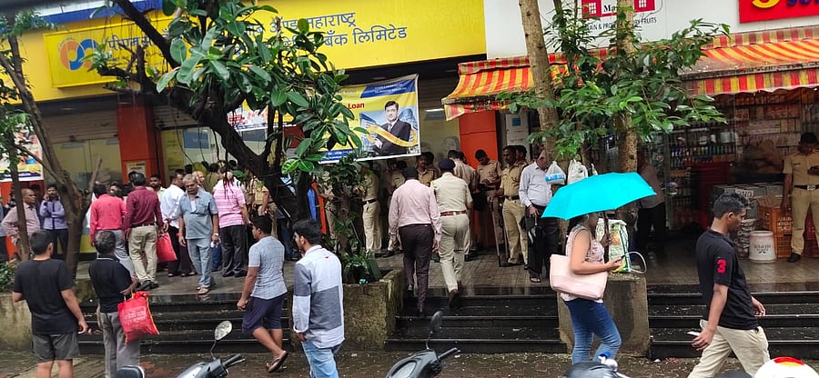 People gather around PMC bank in Mumbai.