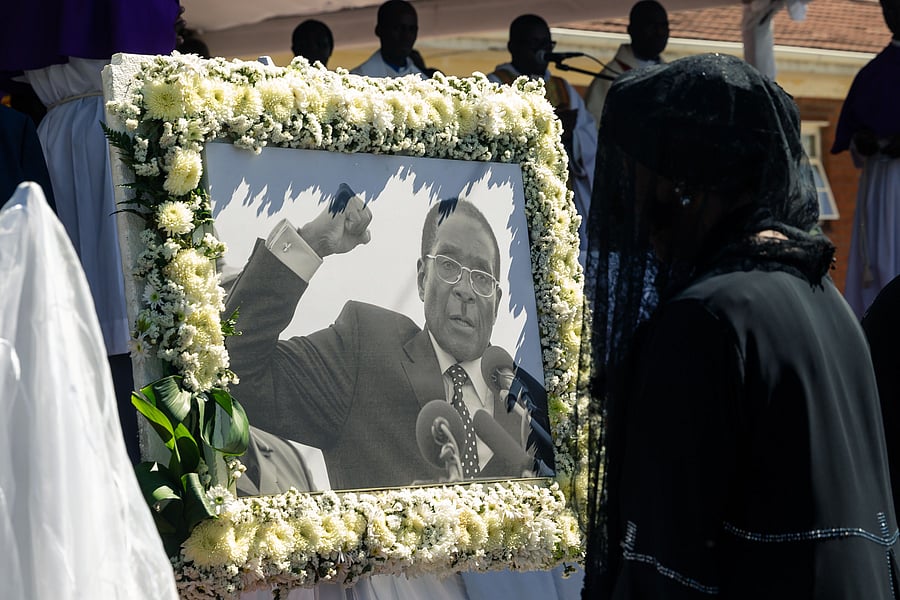 Former first lady Grace Mugabe walks past a portrait of Robert Mugabe during the burial of the former Zimbabwe leader at his home village in Kutama. (AFP Photo)