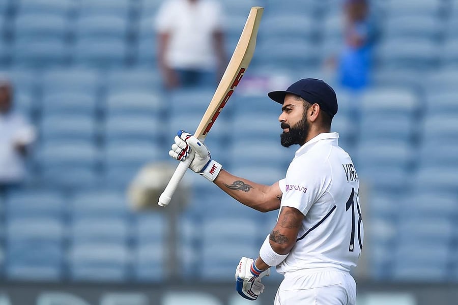 India's cricket team captain Virat Kohli celebrates after scoring a double century (200 runs) during the second day of the second Test cricket match between India and South Africa at Maharashtra Cricket Association Stadium in Pune on October 11, 2019. (Photo by Punit PARANJPE / AFP)