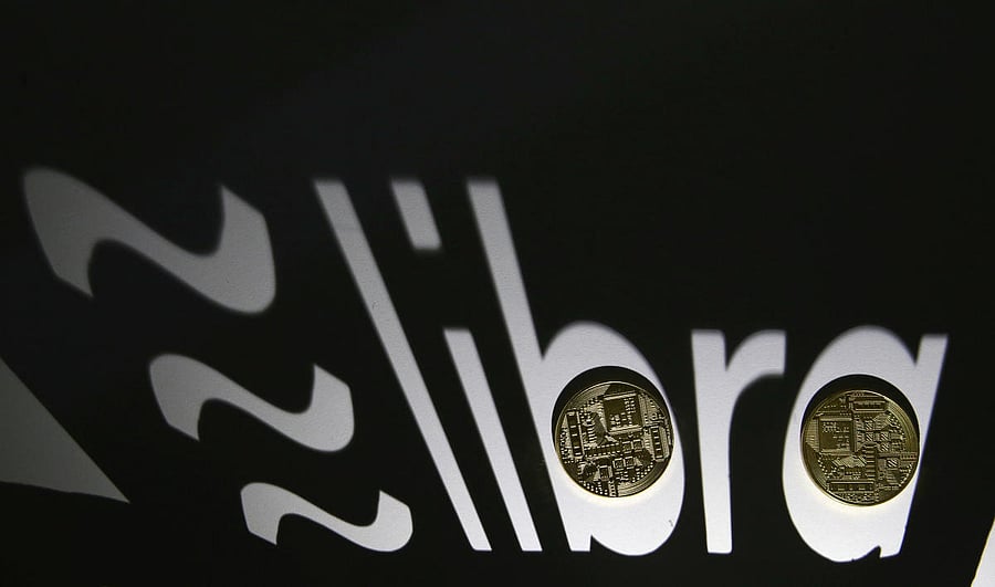 Shadow of a 3D-printed Facebook Libra cryptocurrency logo is seen near cryptocurrency representation in this illustration taken, September 13, 2019. Photo/Reuters