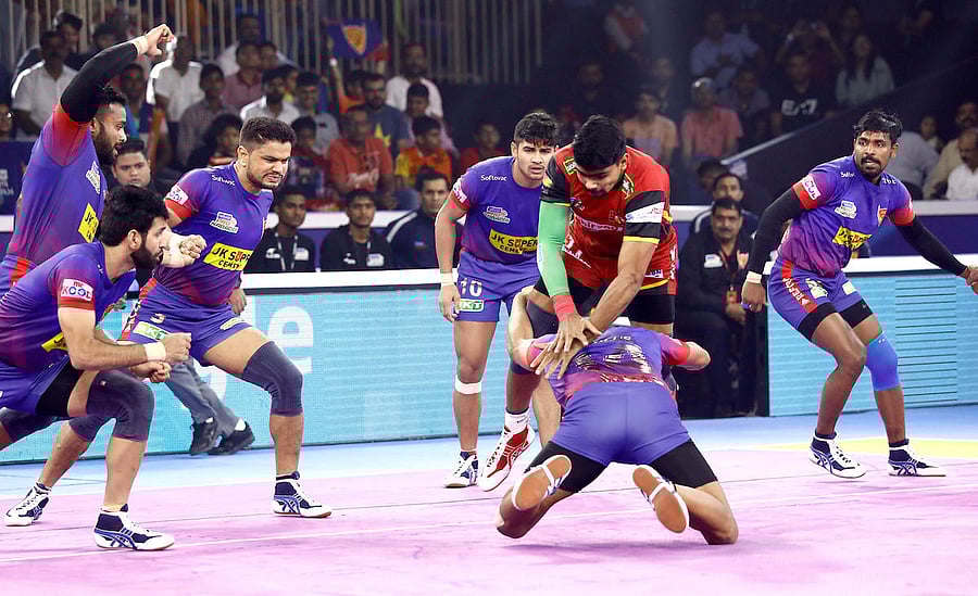 Bengaluru Bulls' Pawan Sehrawat (in red) being tackled by Dabang Delhi KC's player in the semifinal of the Pro Kabaddi League season 7