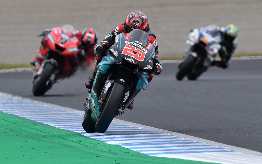 Petronas Yamaha SRT rider Fabio Quartararo of France (C) leads Ducati Team rider Danilo Petrucci of Italy (L) during the second free practice session at the Twin Ring Motegi circuit in Motegi, Tochigi prefecture. AFP