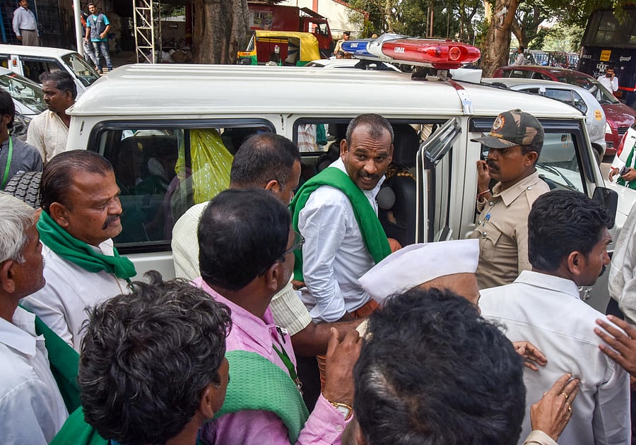 Policy accompany farmers to Raj Bhavan from Krantiveera Sangolli Rayanna railway station in Bengaluru on Friday. The farmers had been staging a protest demanding government notify Kalasa-Banduri project since Thursday. DH Photo