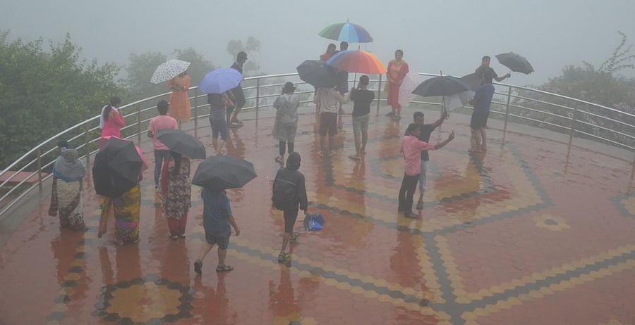 Tourists enjoy the beauty of Raja Seat in Madikeri.