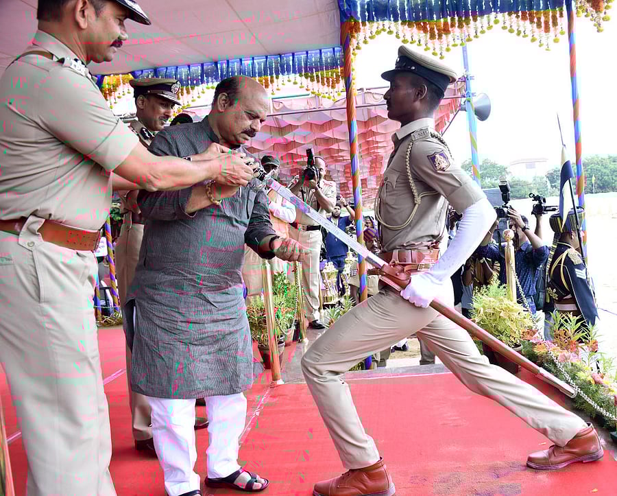 Home Minister Basavaraj Bommai presents the best probationer sword to S Charan in Mysuru. DH Photo