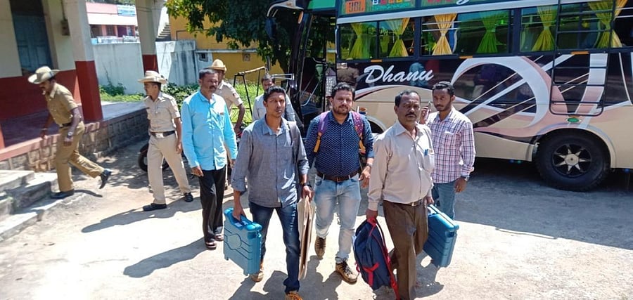 Polling staff leave for their respective polling booths in Kushalnagar on Saturday.