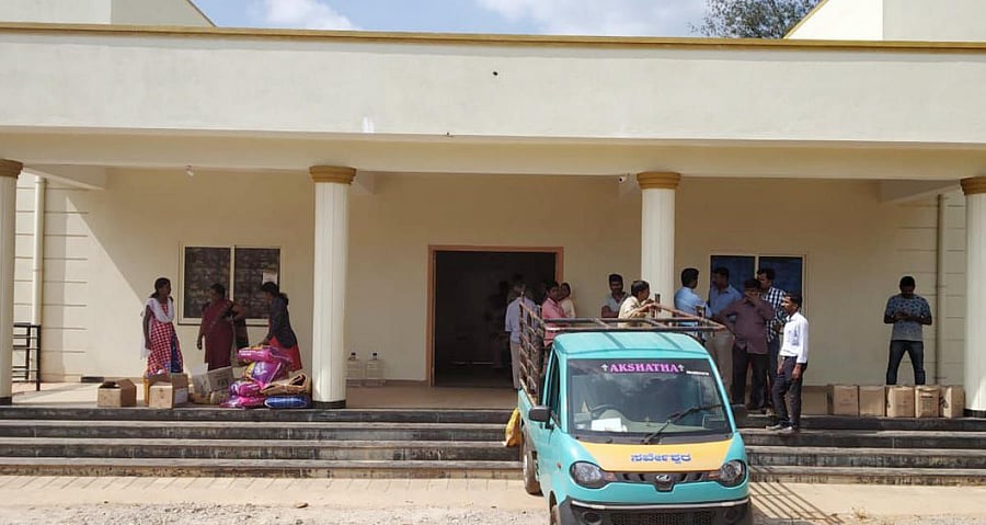 Awaiting distribution: A view of the Madikeri Junior College building where the relief materials have been stored. (Right) Rice stored in a godown.
