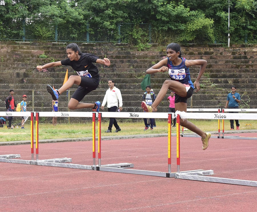 Athletes take part in hurdles at the Dakshina Kannada Junior Athletics meet at Mangala Stadium in Mangaluru on Saturday.