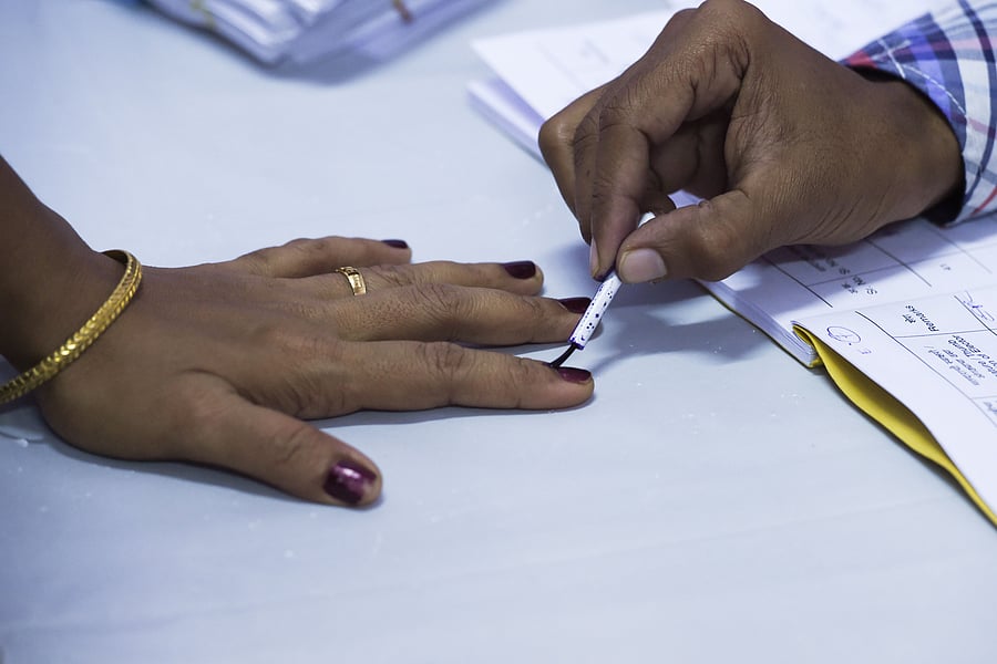 A woman has her finger marked with ink after casting her vote at a polling station during the State Assembly election in Mumbai. (AFP Photo)