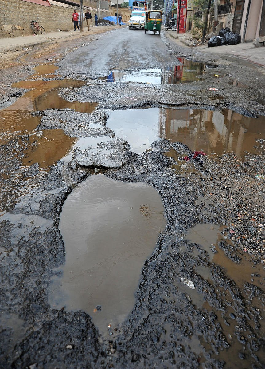 The civic body should make arrangement to install display boards announcing the compensation given to victims of accidents caused by potholes in the city. DH file photo