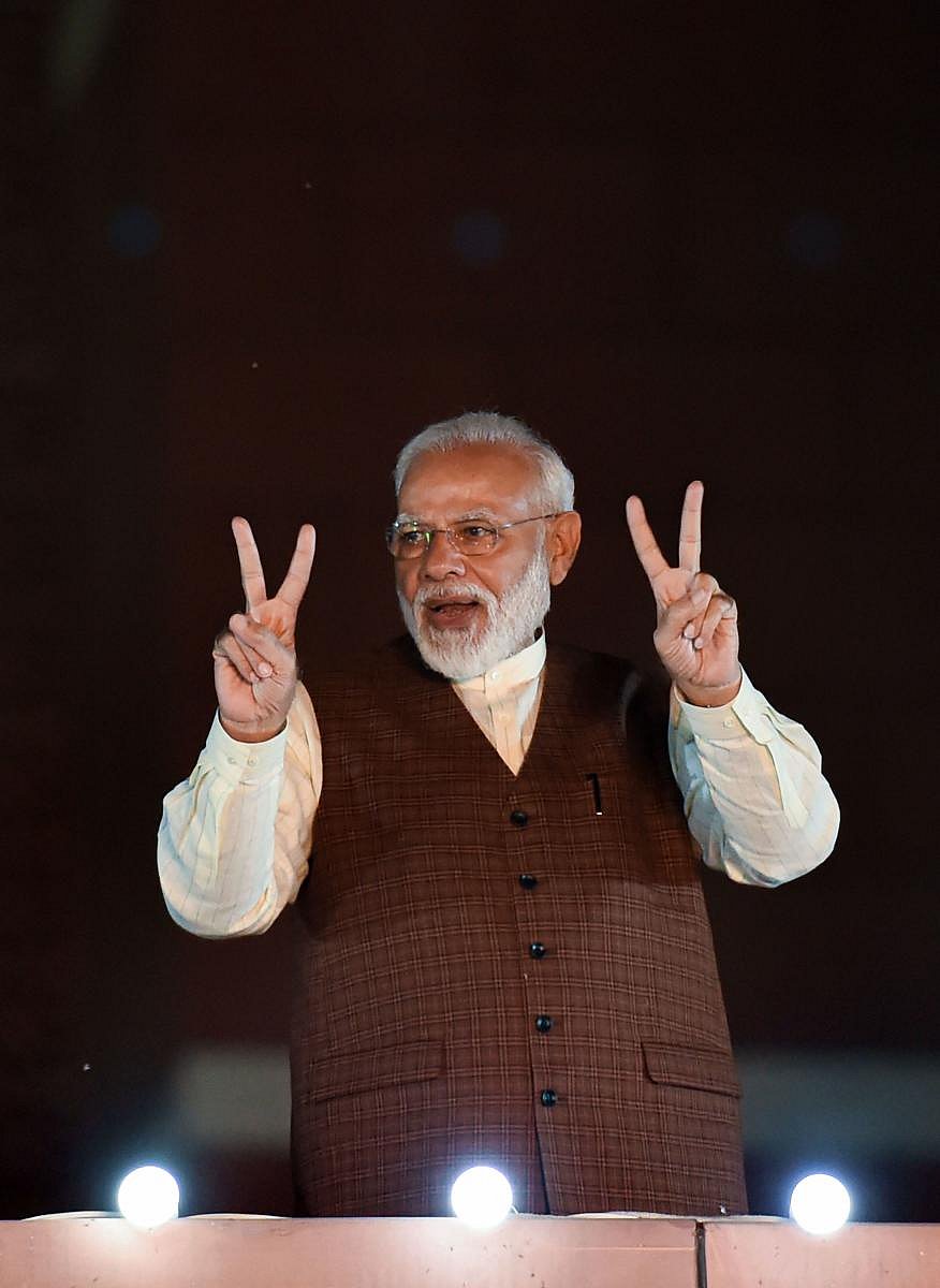 Prime Minister Narendra Modi arrives to address his supporters after the party's victory in both Haryana and Maharashtra Assembly polls