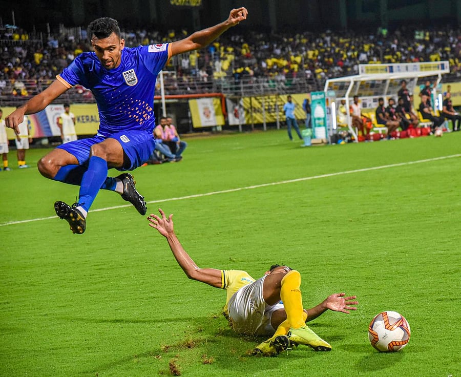 Kerala Blasters FC players (in yellow) and Mumbai City FC in action during the 6th season of Indian Super League (ISL) 2019, at Jawaharlal Nehru International Stadium in Kochi, Thursday, Oct. 24, 2019. (PTI Photo)