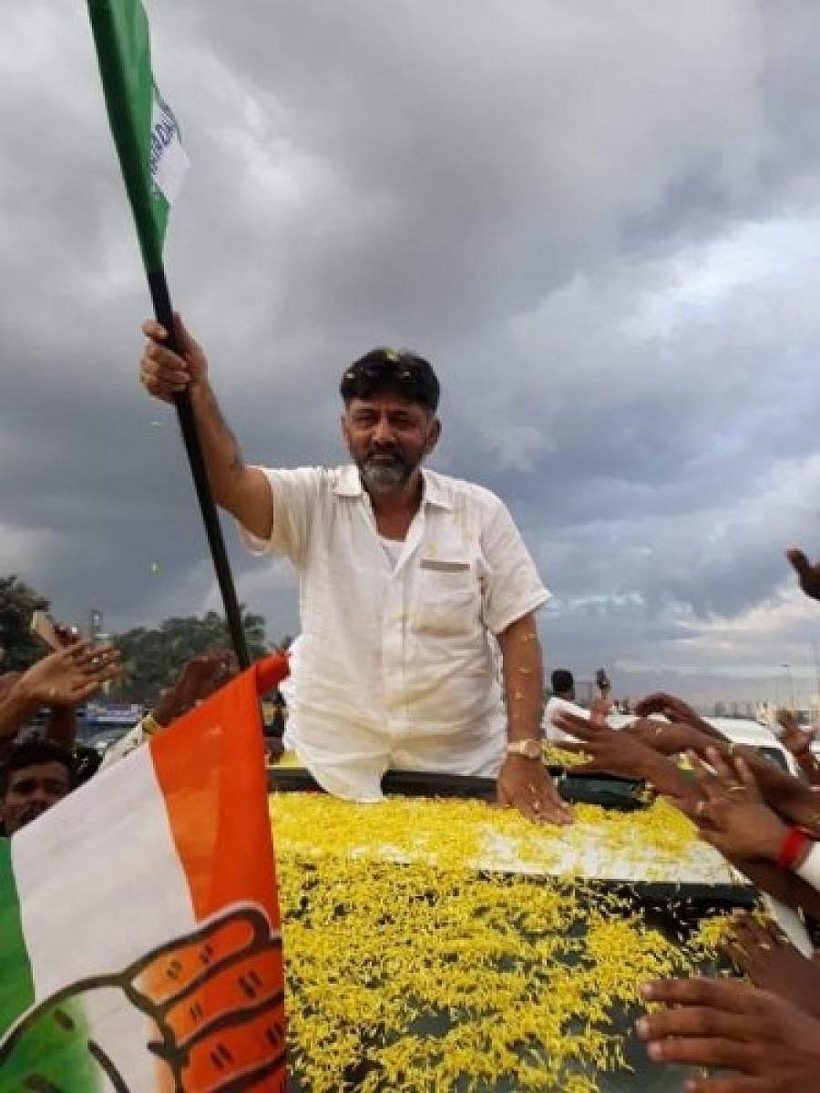 Former Congress minister D K Shivakumr waves JD(S) flag during a rally organised to welcome him on his arrival in Bengaluru, recently.