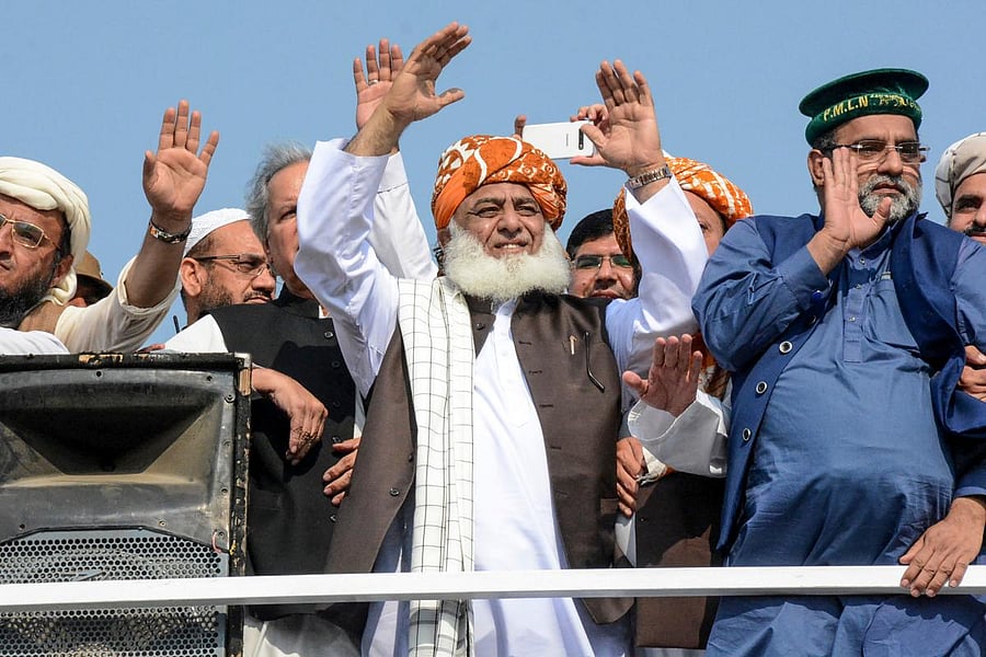 Chief of the Jamiat Ulema-e-Islam party Maulana Fazlur Rehman (C) gestures to supporters on his arrival during an anti-government "Azadi March" march towards Islamabad. (AFP Photo)