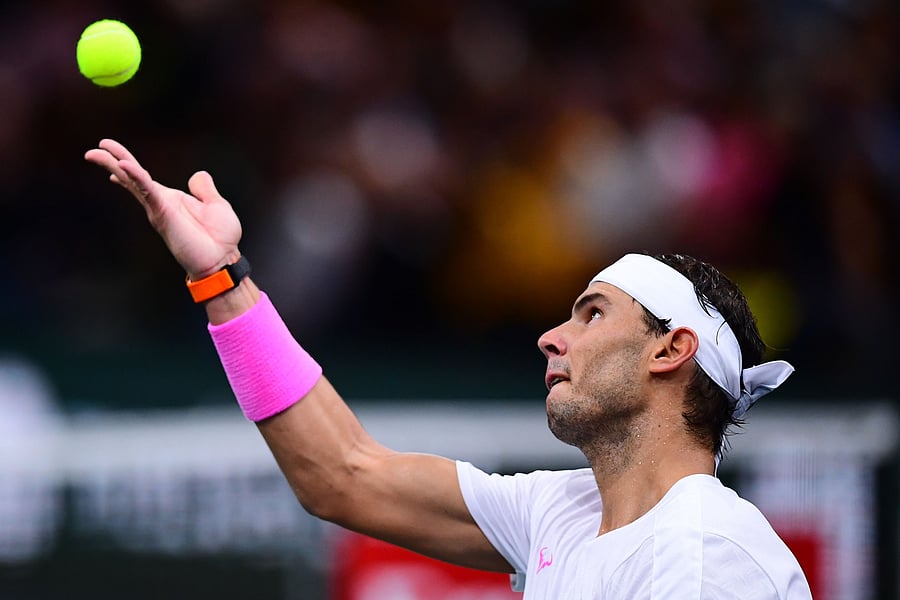 Spain's Rafael Nadal eyes the ball as he returns the ball to France's Jo-Wilfried Tsonga during their men's singles quarter-final tennis match at the ATP World Tour Masters 1000 - Rolex Paris Masters - indoor tennis tournament at The AccorHotels Arena in Paris. (AFP Photo)