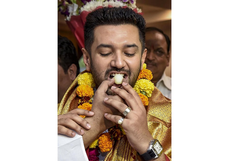 Newly-elected President of Lok Janshakti Party Chirag Paswan being offered sweets, in New Delhi. (PTI Photo)