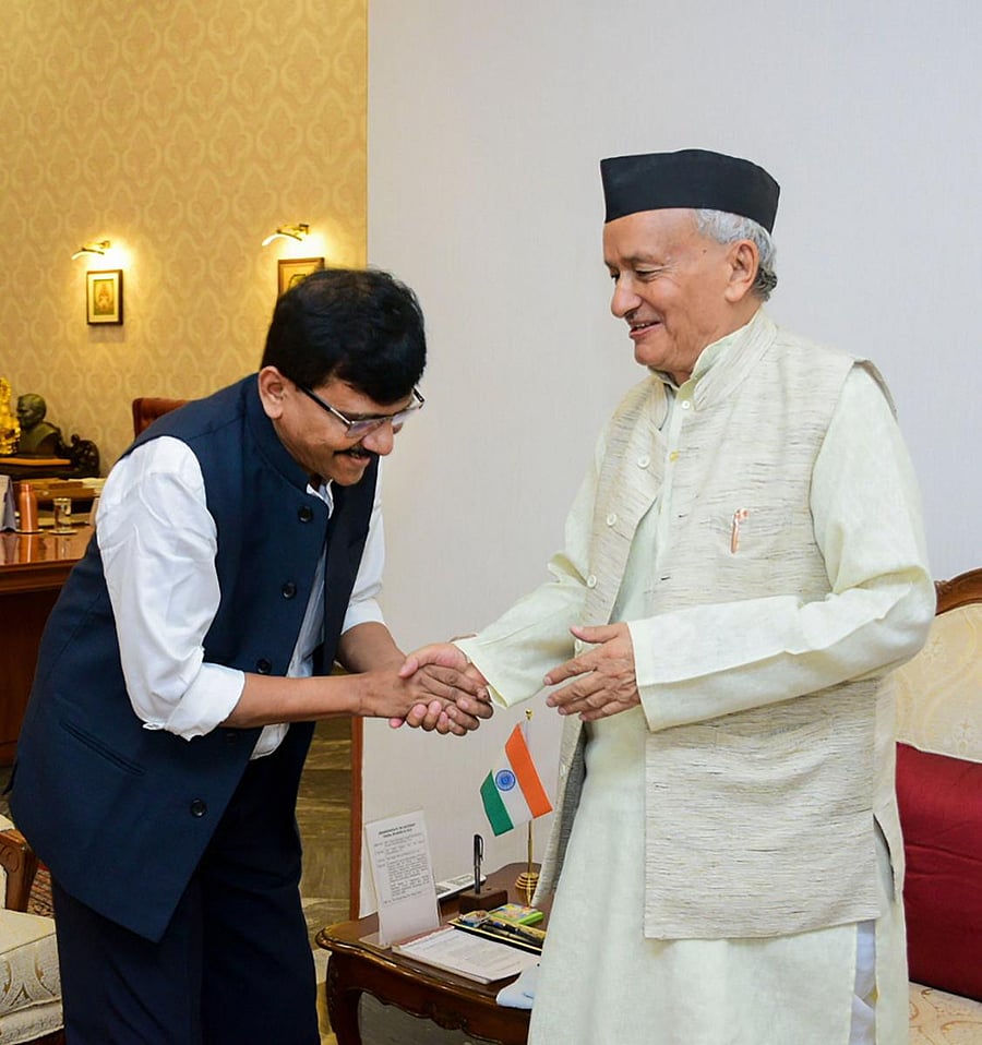 Maharashtra Governor Bhagat Singh Koshyari (R) shakes hands with Shiv Sena spokesman Sanjay Raut (L) (PTI Photo)