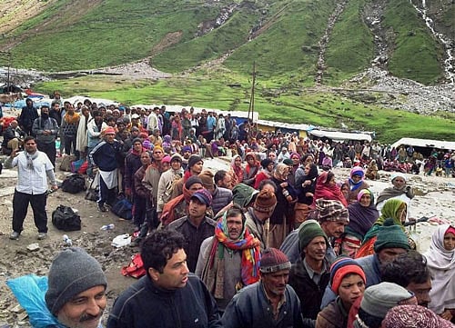 Stranded pilgrims wait for rescue helicopters of Army and IAF near flood-hit Kedarnath shrine in Rudraprayag on Thursday. PTI Photo