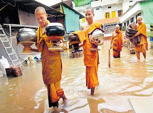 FLOODEDABODE: Buddhist monks move out of a monastery in flood- hit Bodhgaya on Wednesday. PTI