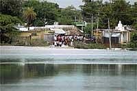 Rain Havoc: Anxious residents of Maddatanuru village look on, as flood water encircles their village cutting off its connection with the rest of regions in Bellary district on Tuesday. DH Photo