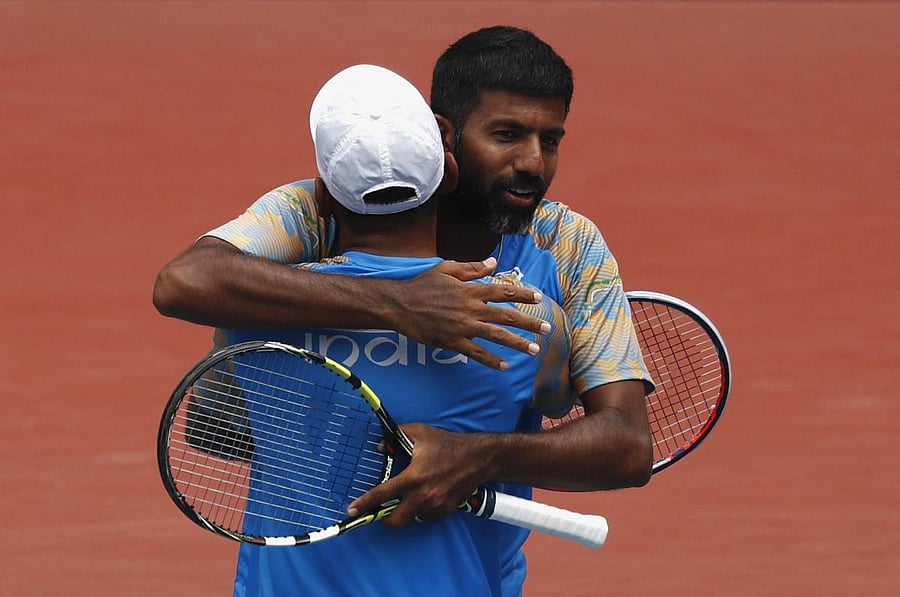 Rohan Bopanna and Divij Sharan of India celebrate after winning the Asian Games doubles gold against Aleksandr Bublik and Denis Yevseyev of Kazakhstan.