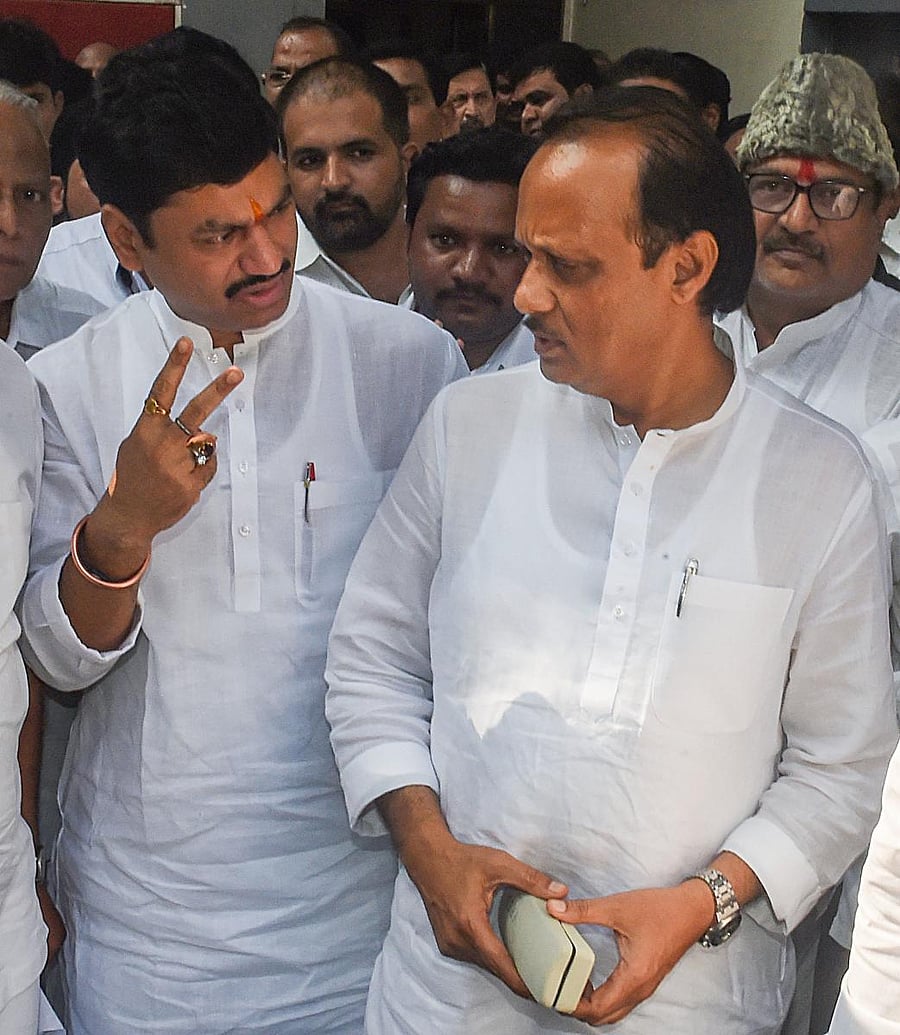 NCP leader's Ajit Pawar and Dhananjay Munde leave after the NCP MLA's meeting, in Mumbai. (PTI Photo)