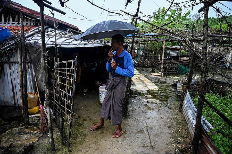 A man standing outside a house in Kyauktalone camp in Kyaukphyu, Rakhine (AFP photo)