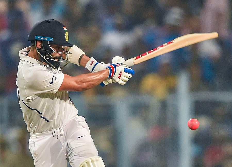Indian Skipper Virat Kohli plays a shot during the 1st pink-ball day/night cricket test match between India and Bangladesh, at Eden Gardens in Kolkata. (PTI Photo)