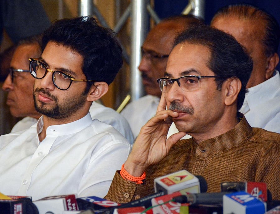 Shiv Sena Chief Uddhav Thackeray with son and Yuva Sena chief Aaditya Thackeray during a joint press conference with NCP chief Sharad Pawar (unseen), in Mumbai, Saturday, Nov. 23, 2019. (PTI Photo)