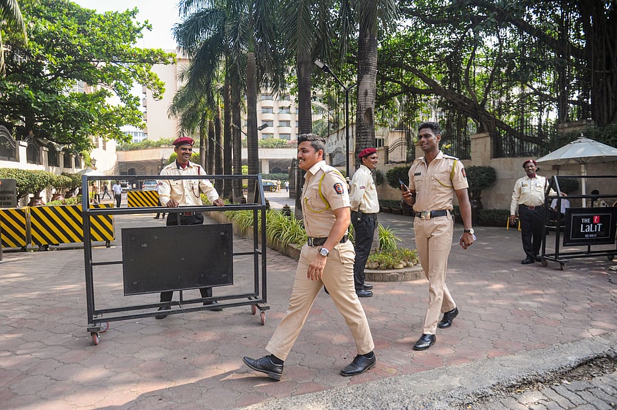 Security personnel keep vigil outside a hotel where Shiv Sena MLA's are residing, at Andheri in Mumbai. (PTI Photo)