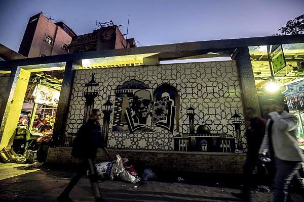 A mural depicting Egyptian novelist and nobel prize winner Naguib Mahfouz is pictured behind the al-Azhar mosque in downtown Cairo on November 26, 2019. (AFP photo)