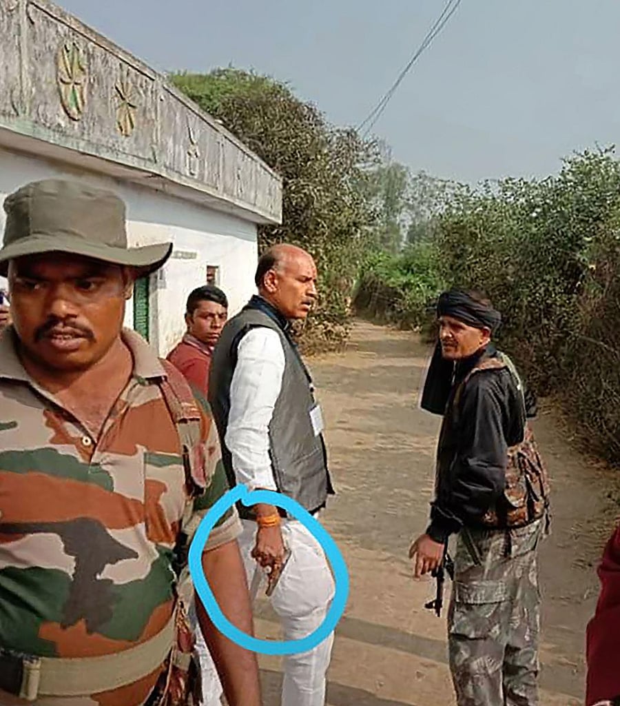 Congress candidate from Daltonganj KN Tripathi brandishes a revolver during the first phase of Jharkhand Assembly elections, in Palamu district, Saturday, Nov. 30, 2019. (PTI Photo)