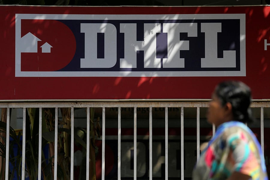 A woman walks past a signboard of Dewan Housing Finance Corporation Ltd. (DHFL) outside its office on the outskirts of Mumbai, India, January 31, 2019. (Reuters Photo)