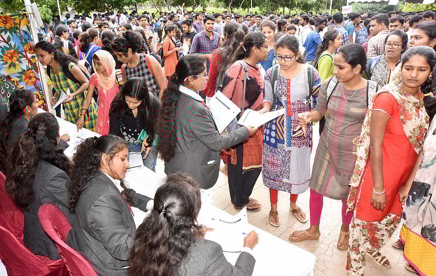 Job aspirants register during the job fair, organised at Karnataka State Open University in Mysuru on Saturday. ( dh photo