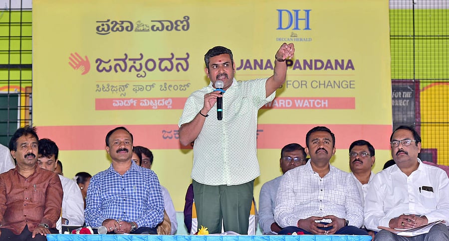 Local corporator K A Munindra Kumar speaks at Janaspandana in Jakkur on Saturday. (L-R) BBMP Yelahanka executive engineer H V Yarrappa Reddy, BWSSB executive engineer Jayashankar, BBMP Yelahanka joint commissioner Dr Ashok and chief engineer S P Ranganath look on.