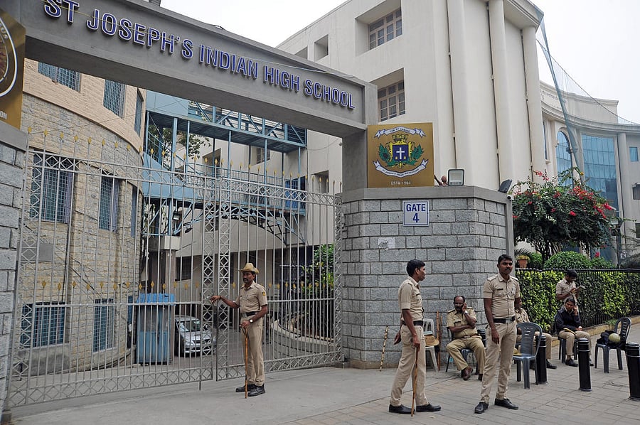 Police guard the strong room at St Joseph's Indian High School on Vittal Mallya Road, where the electronic voting machines have been kept, in Bengaluru on Friday. DH Photo: Pushkar V