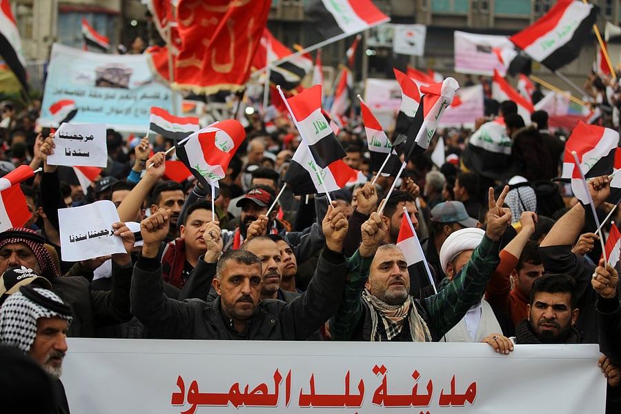 Iraqi demonstrators wave national flags as the take part in an anti-govenment demonstration in the capital Baghdad's Tahrir Square. (AFP Photo)