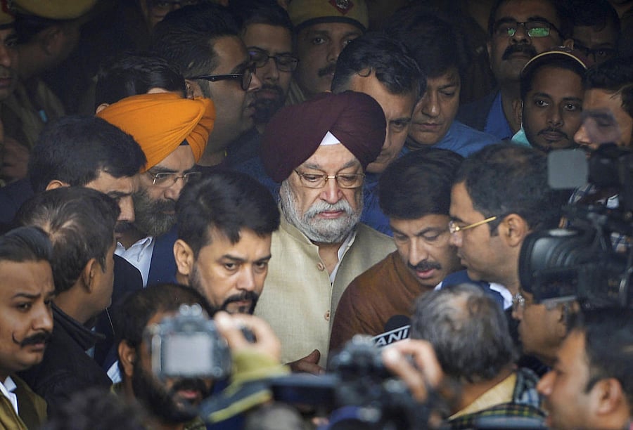 Union Minister Hardeep Singh Puri, MoS Finance Anurag Thakur and Delhi BJP President Manoj Tiwari leave after visiting the site of a factory at Rani Jhansi Road where a major fire broke out. PTI
