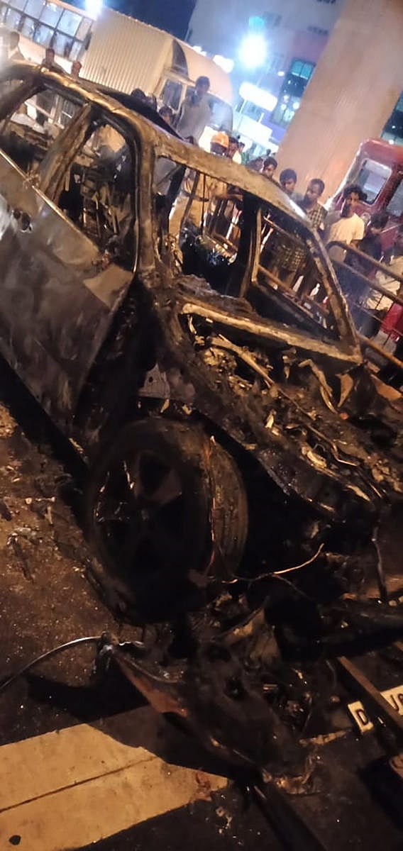 The charred remains of the car that caught fire near Peenya on Sunday. Special Arrangement