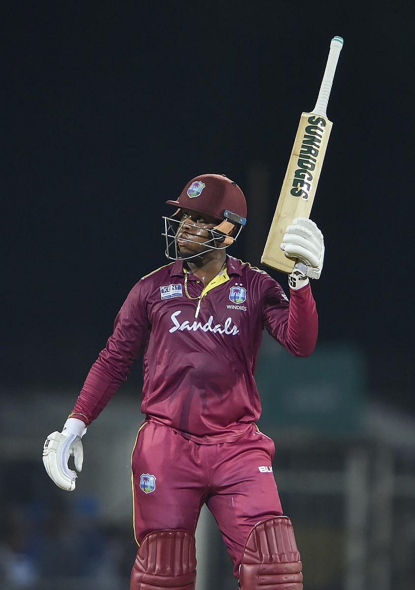 West Indies batsman Shimron Hetmyer raises his bat to celebrate half century during the first One-Day International (ODI) cricket match against India, at MAC Stadium in Chennai, Sunday, Dec. 15, 2019. (PTI Photo)