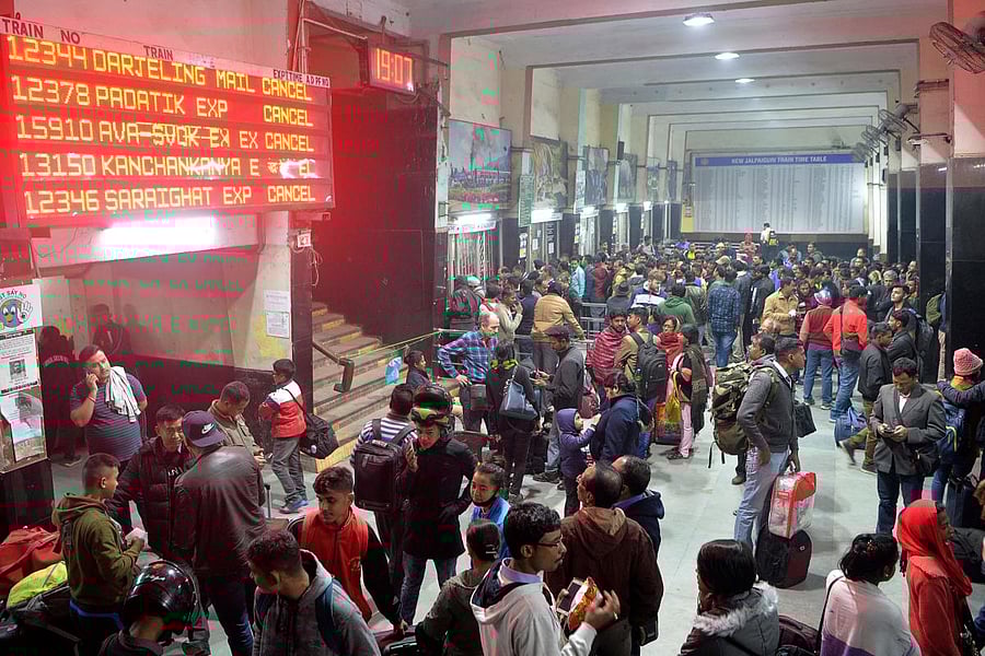 Commuters wait as trains has been cancelled at New Jalpaiguri Railway station on the outskirts of Siliguri. (AFP Photo)