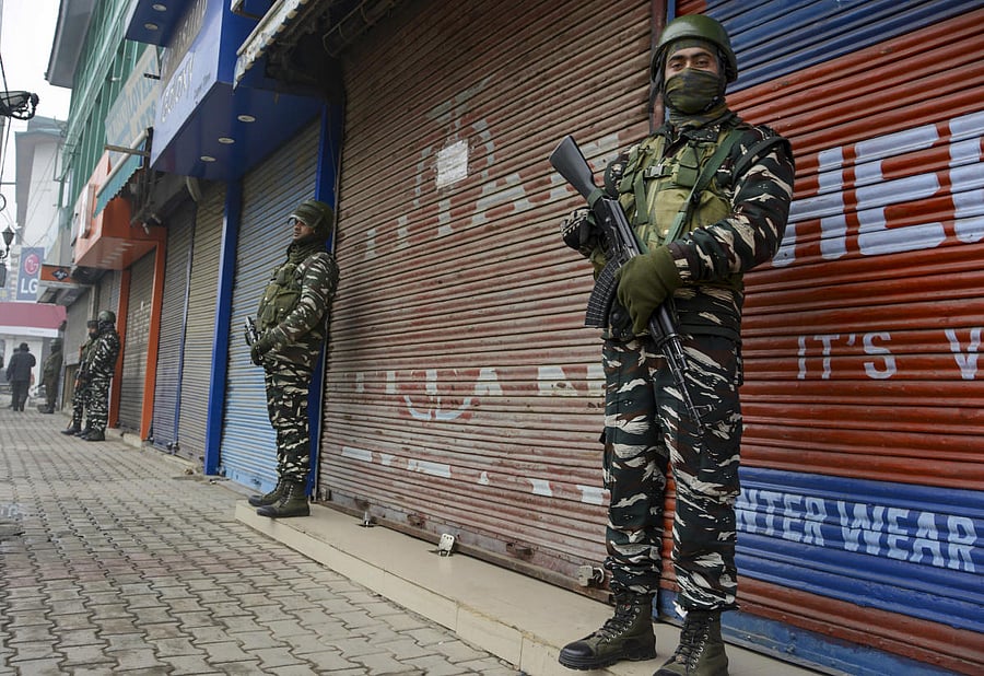 Security personnel stand guard at a closed market in Srinagar (PTI Photo)