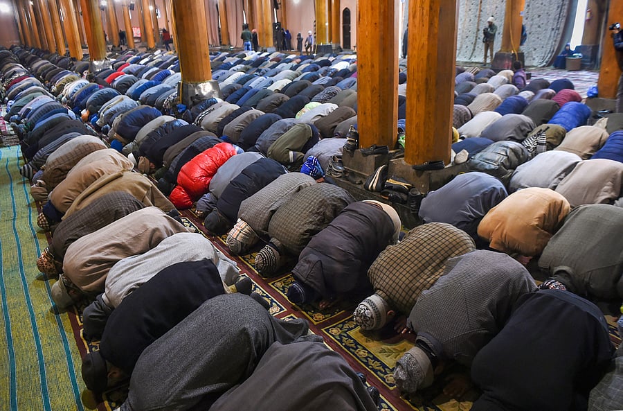People offer congregational prayers at historical Jamia Masjid, in Downtown Srinagar. (PTI Photo)