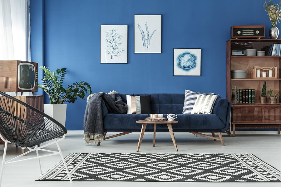 Classic blue used as accents, like an accent wall, sofa or kitchen cabinets, works better than an all-blue scheme.