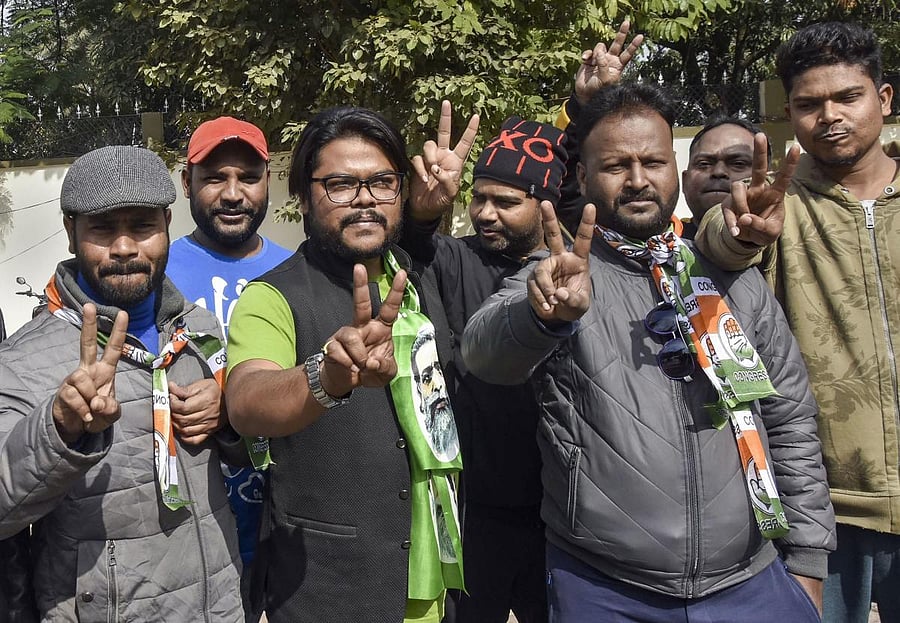 Jharkhand Mukti Morcha (JMM) and Congress Party workers flash victory sign during the counting of votes for Jharkhand Assembly Elections results. (PTI photo)