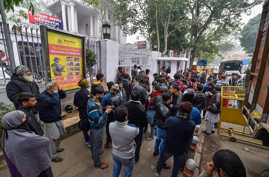 Family members of protestors arrested for violence during yesterday's rally against the Citizenship Amendment Act (CAA), wait for their release outside Daryaganj police station. PTI