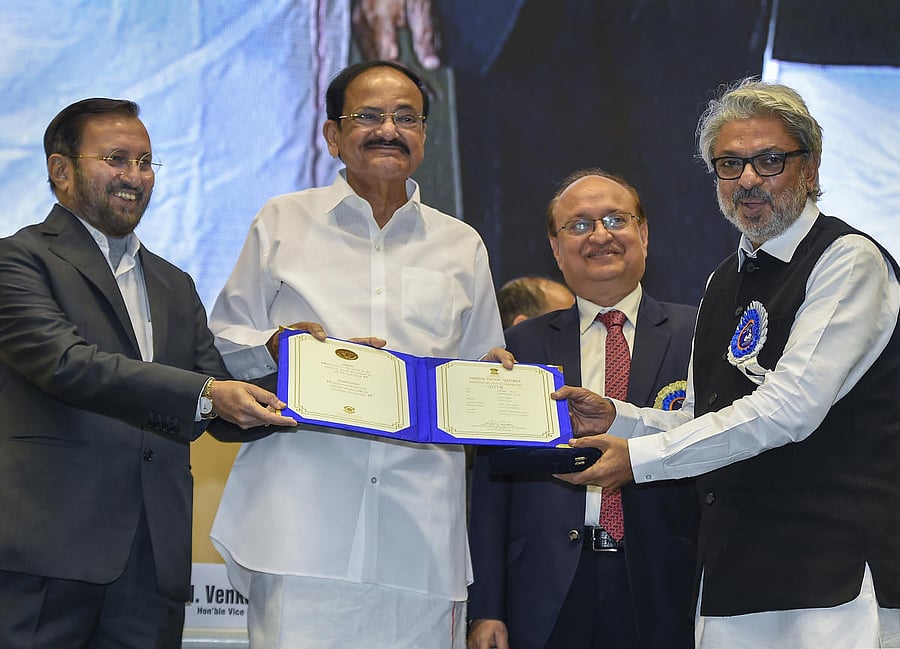 ice-President Venkaiah Naidu and Union Minister Prakash Javadekar present the best music director award to Sanjay Leela Bhansali for his movie 'Padmavaat ' during the 66th National Film Awards function in New Delhi, Monday, Dec. 23,2019. (PTI Photo)